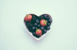 blueberries, blackberries and strawberries in heart shaped bowl