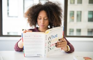 woman reading book on google