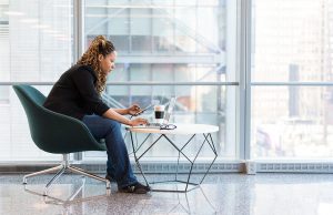 woman sitting in chair working at desk