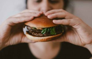 woman holding hamburger